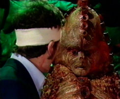 DOCTOR WHO - TERROR OF THE ZYGONS - Ian Marter as Harry Sullivan confronted by Broton